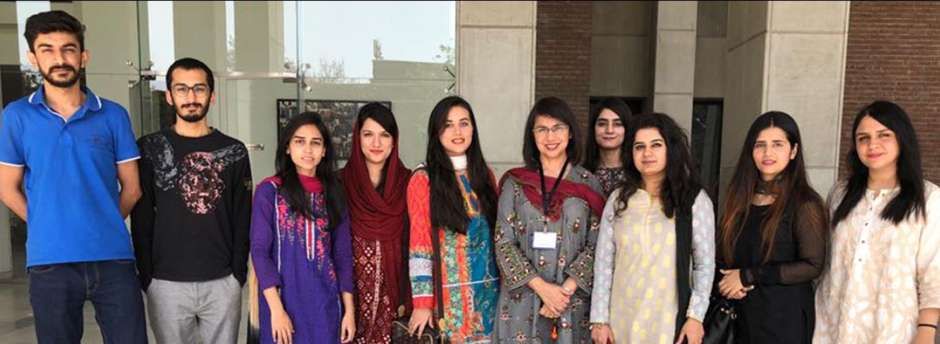 Dr. Shaper and her Biology team standing in front of the SBASSE building