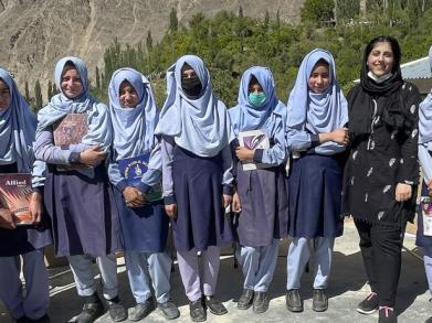 Girls in uniform standing next to a LCSS team member